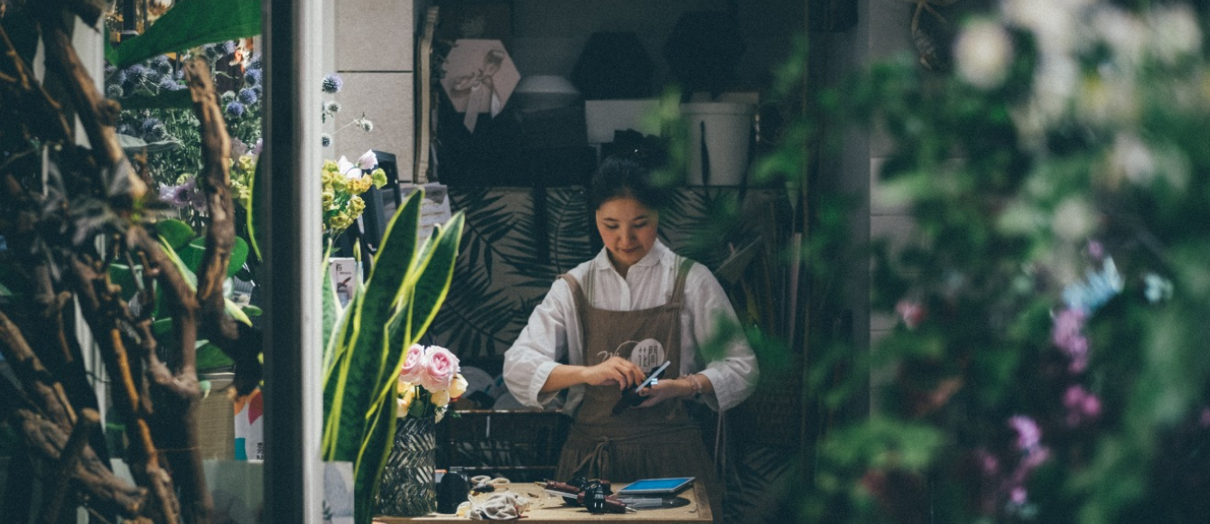 Florist arranging flowers at the workbench inside the Floritta studio in London