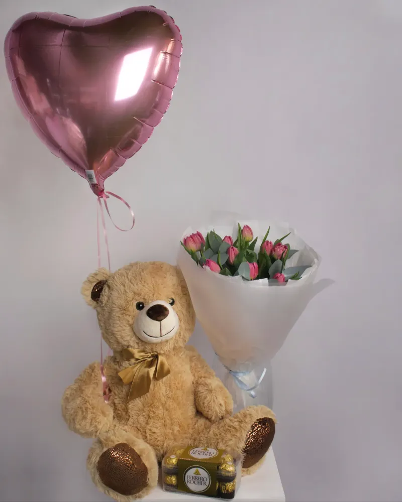 Romantic gift set with teddy bear, pink tulips, and chocolates