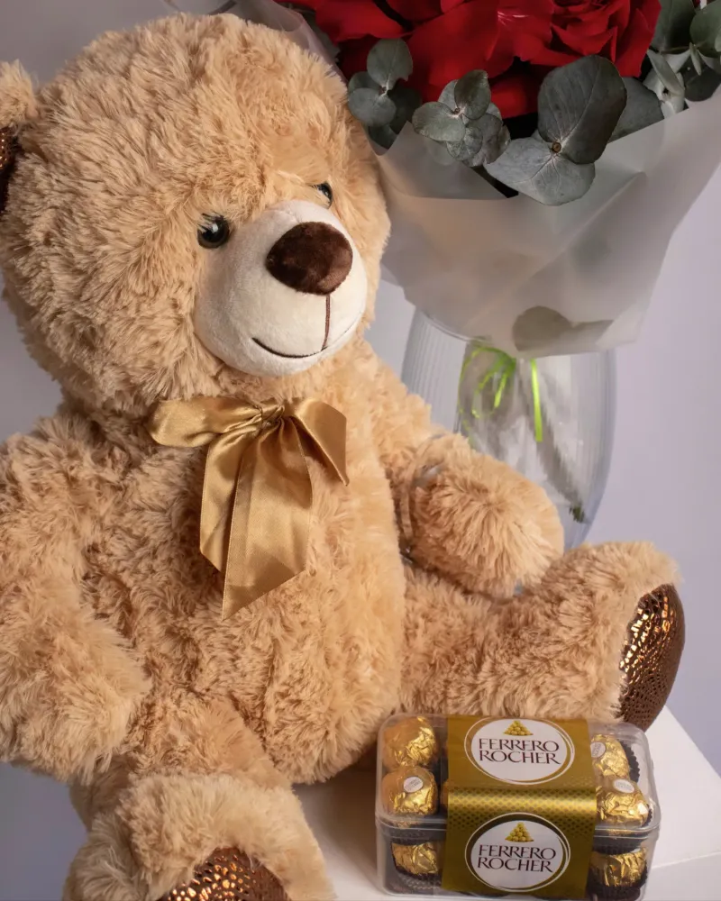 Romantic gift set with teddy bear, red roses, chocolate, and heart balloon